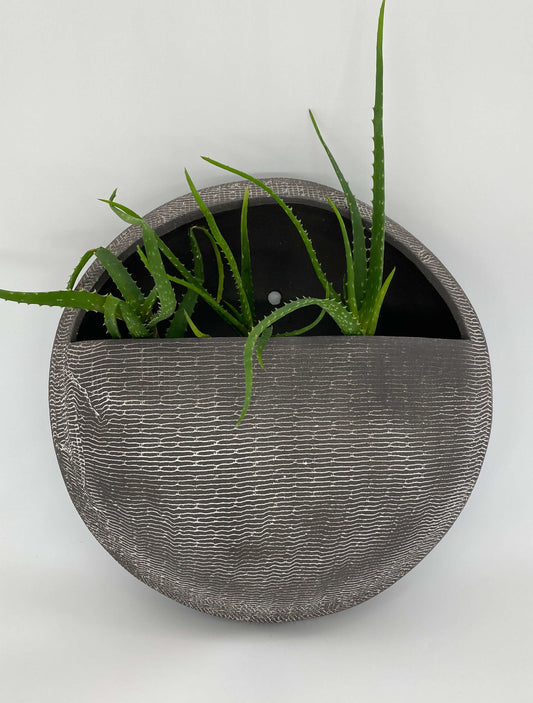 Black ceramic wall hanging planter with white texture