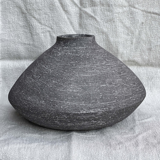 Black, wide belly ceramic decor vessel with white texture.