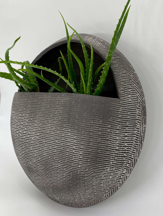 Black ceramic wall hanging planter with white texture