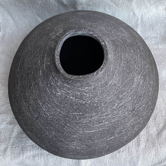 Black, wide belly ceramic decor vessel with white texture.